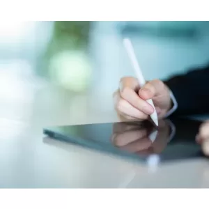 person writing in portfolio